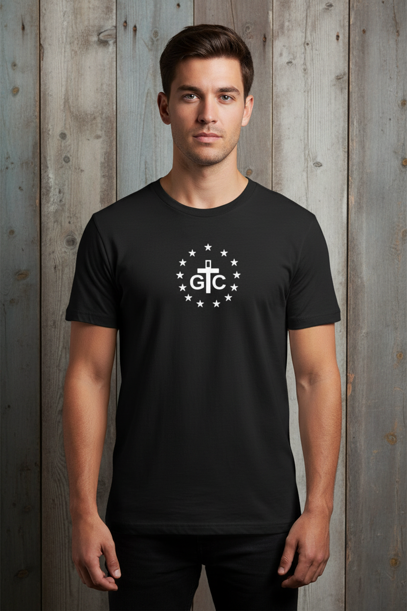 Male model wearing exact black G&C t-shirt against rustic wood